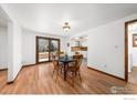Cozy dining room with wood table, seating, and access to the backyard at 1501 Willow Dr, Berthoud, CO 80513