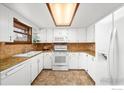 Bright kitchen with white cabinetry, updated appliances, and stylish countertops at 1501 Willow Dr, Berthoud, CO 80513