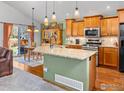 Spacious kitchen features granite countertops, stainless steel appliances, and an island with a sink at 1508 Aspenwood Ln, Longmont, CO 80504