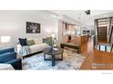 Inviting living room with plush seating, stylish decor, and hardwood floors flows into kitchen at 1836 Grove St # 105, Denver, CO 80204