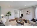 Cozy living room with stylish seating, a decorative rug, and a view into other rooms at 319 Carter Ln, Longmont, CO 80501