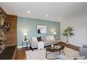 Bright living room featuring a stylish sofa, modern decor, and warm wood flooring at 319 Carter Ln, Longmont, CO 80501