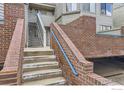 Exterior steps with brick detail and blue railing, leading to upper-level units at 3260 47Th St # 108A, Boulder, CO 80301