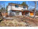 This two-story home features modern design with wood accents, porch swing, and landscaped front yard at 3495 Endicott Dr, Boulder, CO 80305