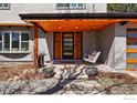 Inviting front porch features a porch swing, natural wood accents, and decorative planters at 3495 Endicott Dr, Boulder, CO 80305
