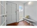 Bright entryway featuring brick flooring, a cushioned bench, and ample natural light at 4015 Wonderland Hill Ave, Boulder, CO 80304
