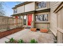 Townhome exterior showcasing a red front door, fenced patio, and planters, inviting entry at 4015 Wonderland Hill Ave, Boulder, CO 80304