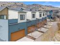 View of modern townhomes with brown garages and mountain views, featuring contemporary architecture at 5318 5Th St # E, Boulder, CO 80304