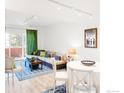 Bright living room with a sliding glass door, cozy sofa, and a small dining area at 624 Pearl St, Boulder, CO 80302