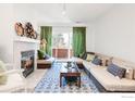 Living room with a fireplace, comfortable seating, and a sliding door to a balcony at 624 Pearl St, Boulder, CO 80302
