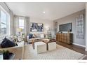 Comfortable living room featuring neutral tones, stylish decor, and large windows for ample natural light at 6512 13Th St, Frederick, CO 80530
