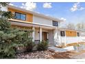 Charming two-story home with white painted brick, wood accents and a welcoming front porch at 6969 Harvest Rd, Boulder, CO 80301