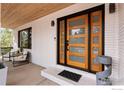 Modern front door with glass panels, showcasing the home's stylish entrance and architectural features at 6969 Harvest Rd, Boulder, CO 80301