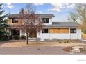 Charming two-story home with a manicured front yard and modern architectural details at 6969 Harvest Rd, Boulder, CO 80301