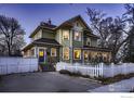 Charming two-story home with a white picket fence and inviting curb appeal at 705 7Th St, Berthoud, CO 80513