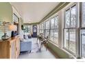 Cozy sunroom with ample windows, comfortable seating, and natural light at 705 7Th St, Berthoud, CO 80513