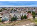 Neighborhood aerial view showcasing a residential area with mature trees and diverse rooftops at 737 Snowberry St, Longmont, CO 80503