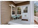 Quaint front porch with seating area, perfect for enjoying the outdoors at 737 Snowberry St, Longmont, CO 80503