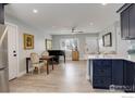 Open-concept living area featuring hardwood floors, neutral tones, and ample natural light at 778 S Nome St, Aurora, CO 80012