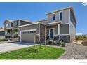 Charming two-story home with a gray exterior, well-kept lawn, and a two-car garage at 786 Griffith St, Lochbuie, CO 80603