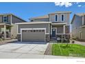 Charming two-story home with a gray exterior, well-kept lawn, and a two-car garage at 786 Griffith St, Lochbuie, CO 80603