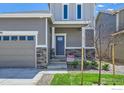 Charming two-story home with a gray exterior, well-kept lawn, and a two-car garage at 786 Griffith St, Lochbuie, CO 80603