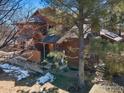 Two-story townhouse with brown siding and steps leading to the front porch at 8015 Holland Ct # A, Arvada, CO 80005