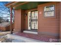 Front entrance to home with a brick-paved porch and an ornate security door at 8015 Holland Ct # A, Arvada, CO 80005