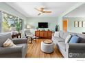 Bright living room with hardwood floors, large windows, and comfortable seating at 884 Ithaca Dr, Boulder, CO 80305