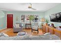 Inviting living room featuring hardwood floors, large windows, and cozy furnishings at 884 Ithaca Dr, Boulder, CO 80305