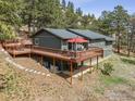 A view of the back of the house featuring an elevated deck with outdoor furniture for relaxing and entertaining at 94 Spring Ln, Boulder, CO 80302