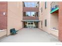 Exterior shot showcases building entrance with bench, automatic doors, and prominent address display at 1053 W Century Dr # 110, Louisville, CO 80027