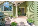 Inviting front porch with seating area and potted plants, creating a warm and welcoming entrance to the home at 1117 Barberry Ct, Boulder, CO 80305