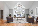 Bright living room with vaulted ceilings, large windows, and stylish furnishings, offering a comfortable space at 1117 Barberry Ct, Boulder, CO 80305