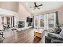 Bright living room with fireplace, hardwood floors and large windows at 13421 Humboldt Way, Thornton, CO 80241
