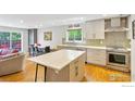Modern kitchen featuring an island with a white countertop, stainless steel appliances, and beautiful hardwood floors at 1709 Alpine Ave # 6, Boulder, CO 80304