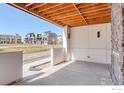 Covered patio with wood ceiling, concrete flooring, and views of the community at 1778 Peak Loop, Broomfield, CO 80023