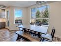 Bright dining area with a large window, a wooden table, bench seating, and views of the outdoors at 2850 E College Ave # 105, Boulder, CO 80303
