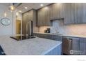 Contemporary kitchen with sleek cabinets, stainless steel appliances, and a large island with bar seating at 2850 E College Ave # 105, Boulder, CO 80303