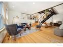 Bright and airy living room with hardwood floors, modern decor, and open staircase at 2937 Champa St # A, Denver, CO 80205