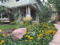 Charming home with beautiful flower garden, lush greenery, and rock landscaping at 3265 6Th St, Boulder, CO 80304