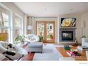 Cozy living room featuring hardwood floors, fireplace, and view to outdoors at 3265 6Th St, Boulder, CO 80304