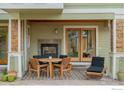 Outdoor patio with table, chairs, fireplace, and access to interior at 3265 6Th St, Boulder, CO 80304
