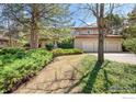 This home boasts a three-car garage and well-maintained landscaping, perfect for a suburban lifestyle at 4062 Pinon Dr, Boulder, CO 80303