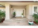 Charming front porch with a welcoming double door entry and stylish decorative plants at 4062 Pinon Dr, Boulder, CO 80303