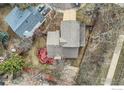Overhead view of a well-maintained home featuring a red deck, mature trees, and a private backyard at 4185 Corriente Pl, Boulder, CO 80301