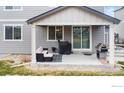 Cozy covered patio with grill, seating, and easy backyard access at 4621 Prairie River Ct, Longmont, CO 80504