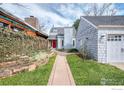 Inviting home showcasing an attached garage, brick walkway, and lush landscaping at 595 Northstar Ct, Boulder, CO 80304