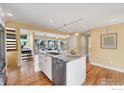 Bright kitchen features granite island, stainless appliances, hardwood floors, and modern lighting at 595 Northstar Ct, Boulder, CO 80304