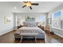 Cozy bedroom with a patterned rug, natural light and a wooden chair, creating a relaxing atmosphere at 630 Benton Ln, Erie, CO 80516